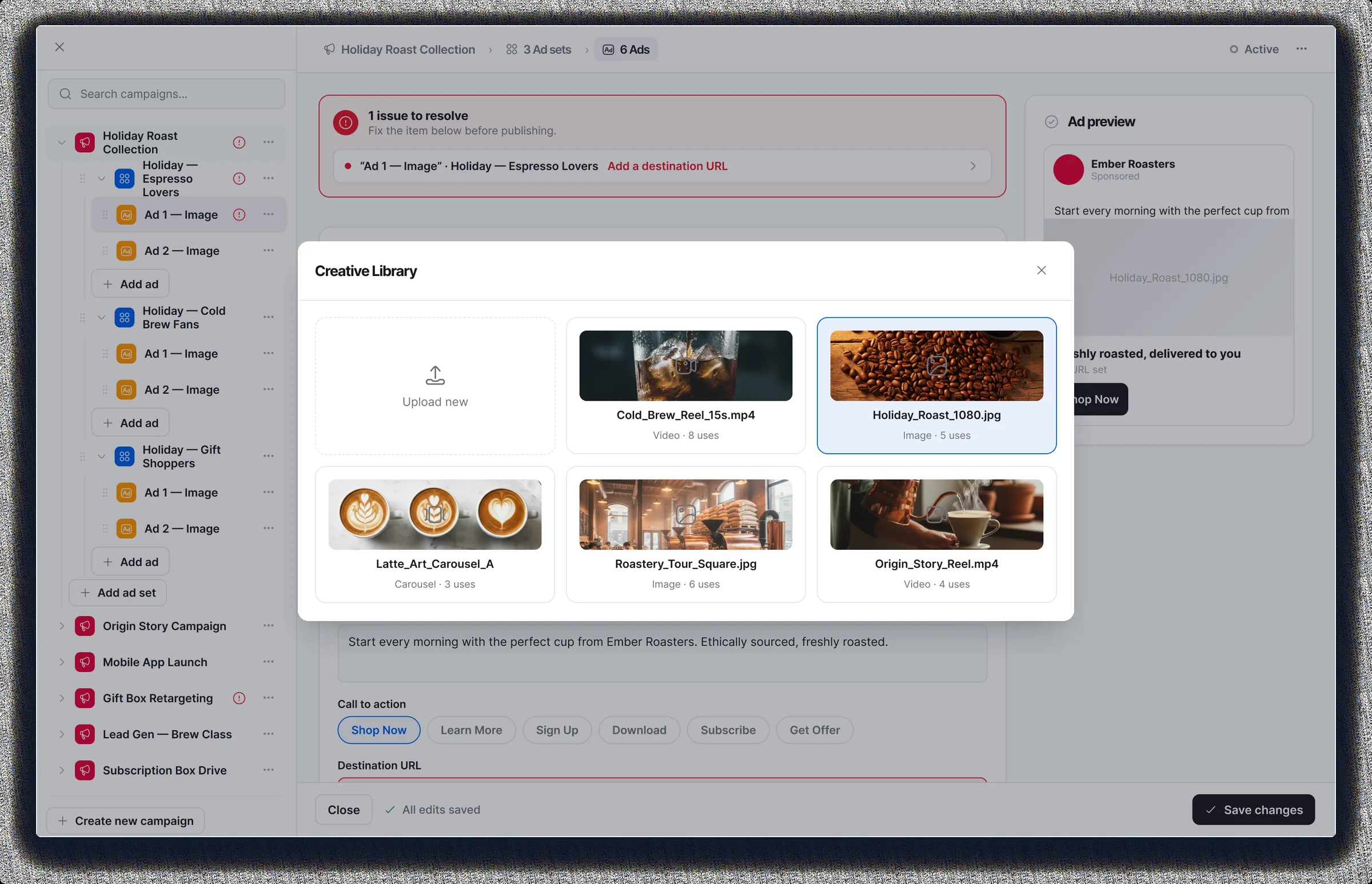 Creative Library picker open over the ad editor: an Upload new tile beside reusable video, image and carousel assets each labeled with its format and use count, with the ad preview and call-to-action row behind it